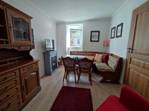 a living room with a table and a couch at Apartament 44 in Lądek-Zdrój