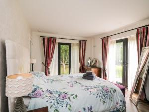 um quarto com uma cama com colcha floral em Thornhill em Enniscorthy