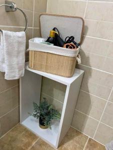 a basket sitting on top of a shelf in a bathroom at Apartament Terra II in Floreşti +12 photos