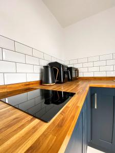 a kitchen with a counter with pots and pans on it at Poldice Valley Apartments in Chacewater