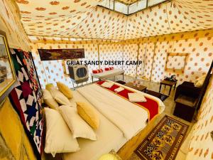 a bedroom with a large bed in a tent at Griat sandy desert camp jaisalmer in Jaisalmer