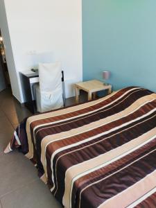a hotel room with a bed and a desk at Gite de prejeurin in Échalas