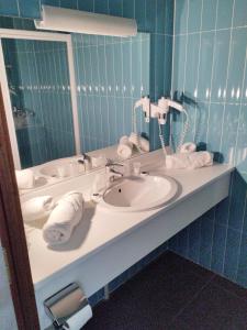 a bathroom with a sink and a mirror at Gite de prejeurin in Échalas