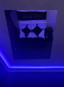 布雷得佛的住宿－The Arc Suites，蓝色灯间的一张床位