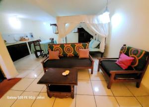 a living room with a couch and chairs and a table at LA MARINA 3 in Ambodifototra