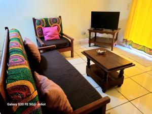 a living room with a couch and a coffee table at LA MARINA 3 in Ambodifototra