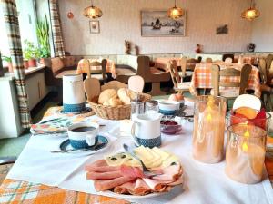 a table with food on it with a table cloth at Pension Schneider in Frauenau +18 photos