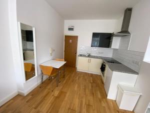 a kitchen with a table and a counter top at Midland apartments- Open plan in Leicester