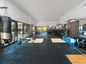 a gym with a punching bag hanging on the wall at Ballito Village Serviced Apartments by DropInn in Ballito