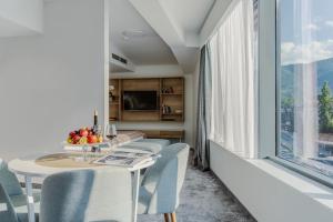 a dining room with a table and chairs and a window at Hotel Aquarion Family & Friends - Destigo Hotels in Zakopane