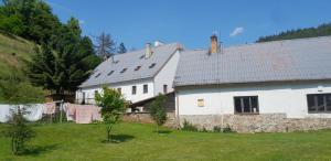 a large white house with clothes hanging on a clothes line at Koberův mlýn in Vysočany