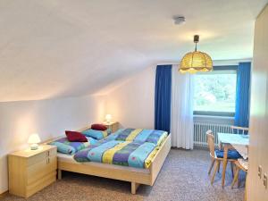 弗勞埃瑙的住宿－Pension Schneider，一间卧室配有一张床、一张桌子和一个窗户。