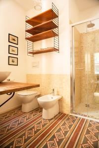 a bathroom with a toilet and a sink and a shower at Urban jungle in Bologna +60 photos