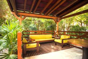 a wooden deck with a couch and chairs and a table at Urban jungle in Bologna