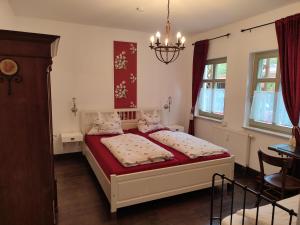 a bedroom with two beds and a chandelier at Ferienwohnung Birkenwerder bei Berlin in Birkenwerder