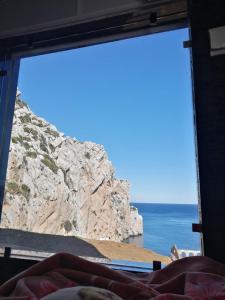 a view of the ocean from a bedroom window at Belyounech studio location de vacance in Tétouan