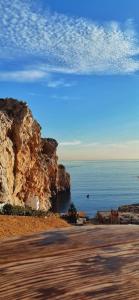 a view of the ocean and a rocky cliff at Belyounech studio location de vacance in Tetouan