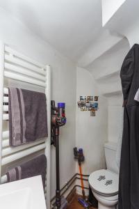 a bathroom with a toilet and a camera at Comme une maison à Paris in Paris