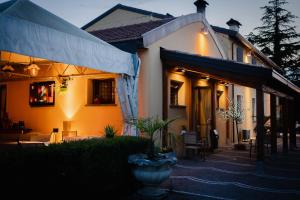 a house with a porch and a patio at SPIEDO IMPERIALE - Locanda e Ristorante in Cotignola