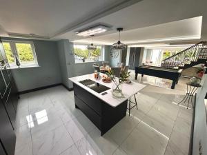 a kitchen and living room with a table and a piano at Moonsticks in Norwich