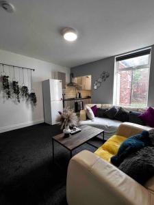 a living room with a couch and a refrigerator at Beautiful 1 Double Bedroom Flat Sheffield Netheredge in Heeley