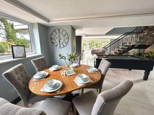 a dining room with a table and a piano at Moonsticks in Norwich