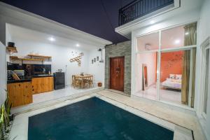 a swimming pool in the middle of a room with a bedroom at Modern Cozy Private Villa with 2Br Rooftop Sunset and Vineyard View in Banjar