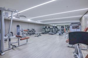 a gym with several treadmills and machines at Masingita Towers Premium Hotel in Johannesburg