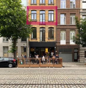 a group of people sitting outside of a building at Boho Chic - your bohemian home in Antwerp in Antwerp