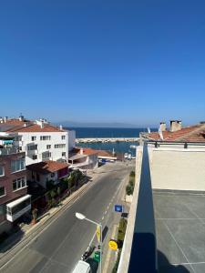 a view of a city street with buildings and the ocean at The Blue House in Burgaz