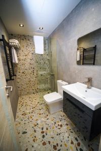 a bathroom with a sink and a toilet and a shower at B&M Hotel in Yerevan