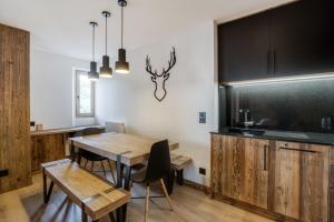 a dining room with a table and a blackboard at Warm apartment nestled in the heart of Megeve in Megève