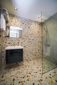 a bathroom with a shower and a sink at B&M Hotel in Yerevan
