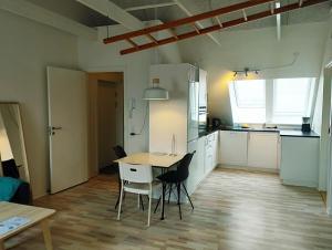 a kitchen and dining room with a table and chairs at Østergade 87. 1 th (id.026) in Esbjerg
