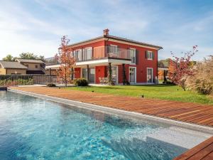 a house with a swimming pool in front of a house at Luxury Golf Villa in Bogogno