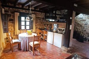 a kitchen with a table and chairs in a room at Casa con encanto LagunaNegra y Urbion in Vinuesa