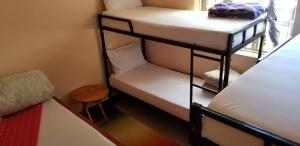 a room with two bunk beds and a table at Maasai Hostel Tanzania in Arusha