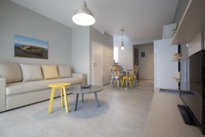 a living room with a couch and a table at Enalia Villas in Ierissos
