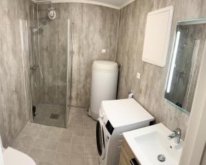 a bathroom with a shower and a toilet and a sink at Tromsdalen Aurora Apartments in Tromsø
