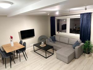 a living room with a couch and a table at Tromsdalen Aurora Apartments in Tromsø