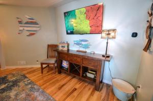 a room with a desk with a lamp and a map on the wall at Riverfront Retreat! Water front and dog friendly! in Two Rivers