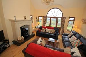 a living room with two couches and a fireplace at Western Greenway B&B in Newport