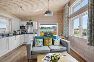 a living room with a couch and a table at Middle Thorne, Great Field Lodges in Braunton