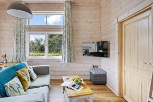 a living room with a couch and a table at Middle Thorne, Great Field Lodges in Braunton