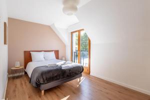 Katil atau katil-katil dalam bilik di Le coin des Songes - Maison avec jardin