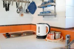 a coffee maker on a counter in a kitchen at Il Mulino - Appartamento Terra in Borzonasca