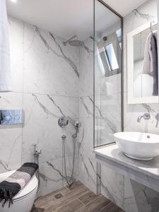 a bathroom with a shower and a toilet and a sink at Evalia Apartments in Hersonissos