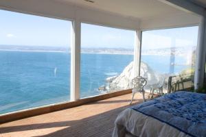 a bedroom with a view of the ocean at Casa Cartagena en acantilado in Cartagena