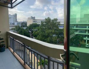 a balcony with a view of a city at Mmr in Manila