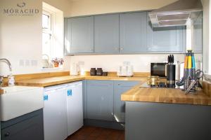 a kitchen with blue cabinets and a counter top at Linton in Kinghorn
